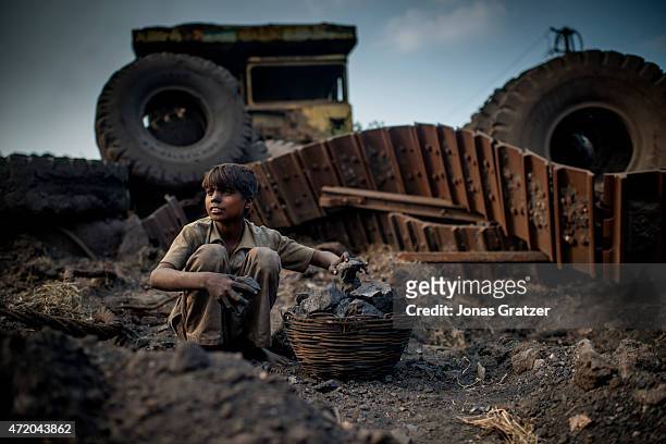 Child laborer working at a coal mine in Jharia. Jharia in India's eastern Jharkand state is literally in flames. This is due to the open cast coal...
