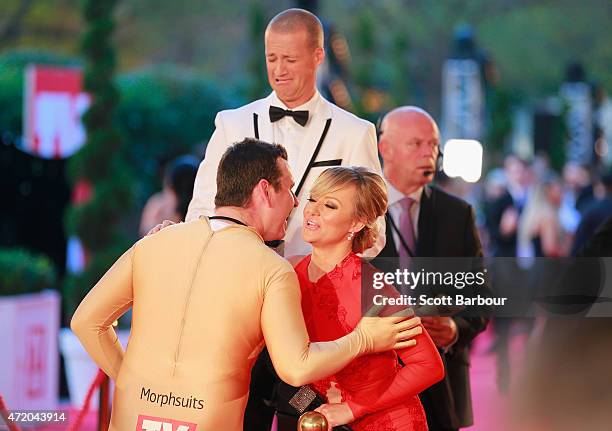 Intern Pete from the Kyle and Jackie O show kisses Shelley Craft as Jules Lund pulls a face at the 57th Annual Logie Awards at Crown Palladium on May...