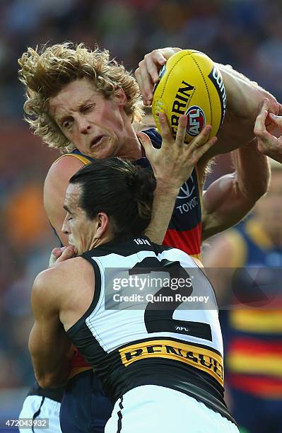 Rory Sloane of the Crows is tackled by Kane Mitchell and Kane Cornes of the Power during the round five AFL match between the Adelaide Crows and the...