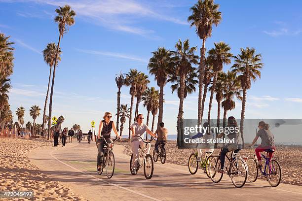 riding bikes at santa monica beach - la waterfront stock pictures, royalty-free photos & images
