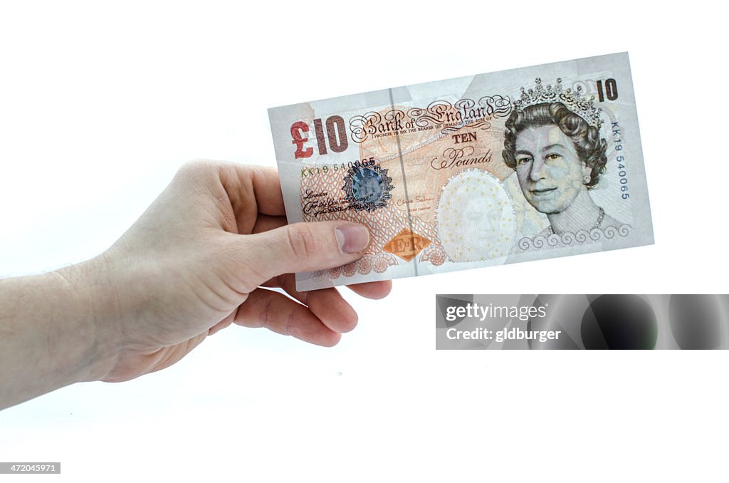 Holding a 10 pound note