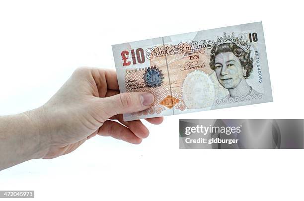 holding a 10 pound note - ten pound note stock pictures, royalty-free photos & images