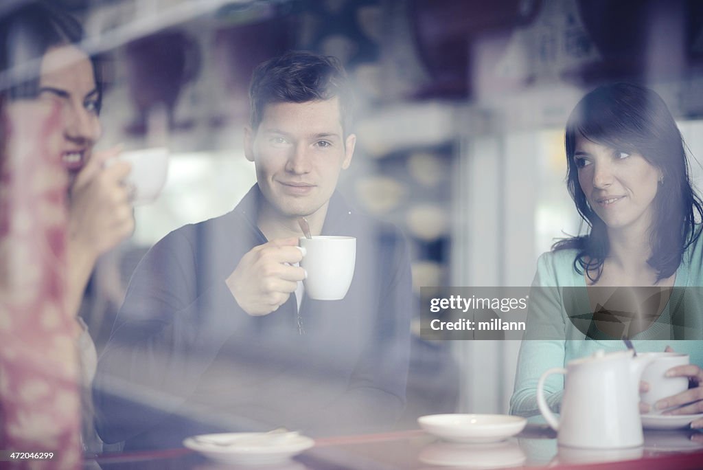 Group of people sitting in a coffee shop.