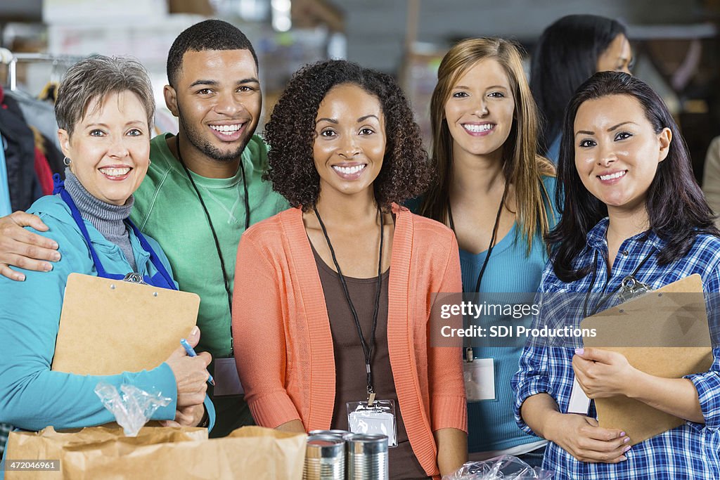 Happy diverse group of volunteers at food bank