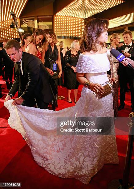 Karl Stefanovic adjusts the dress of Lisa Wilkinson at the 57th Annual Logie Awards at Crown Palladium on May 3, 2015 in Melbourne, Australia.