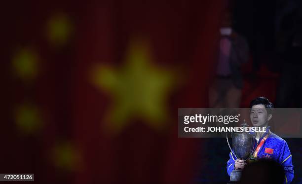 Ma Long of China poses with his trophy after winning the men's final match against Fang Bo of China at the 2015 World Table Tennis Championships at...