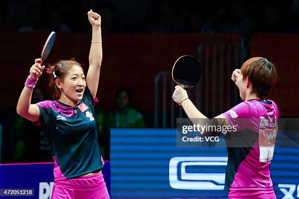 Liu Shiwen and Zhu Yuling of China celebrate after winning women's doubles final match against Ding Ning and Li Xiaoxia of China on day eight of the...