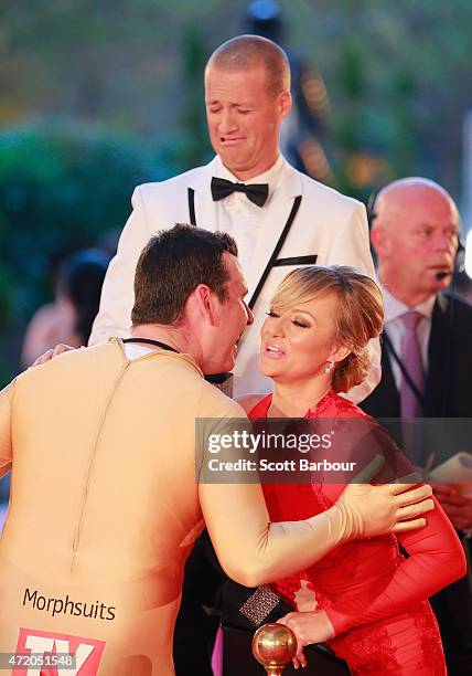 Intern Pete from the Kyle and Jackie O show kisses Shelley Craft as Jules Lund pulls a face at the 57th Annual Logie Awards at Crown Palladium on May...