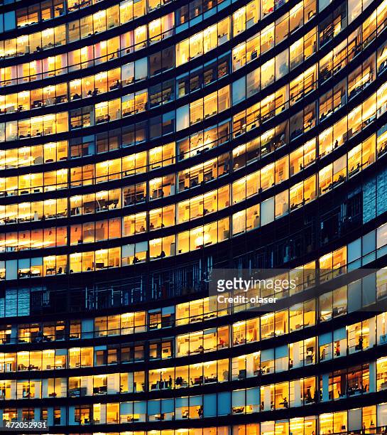 office building at night with illuminated windows - licht natuurlijk fenomeen stockfoto's en -beelden
