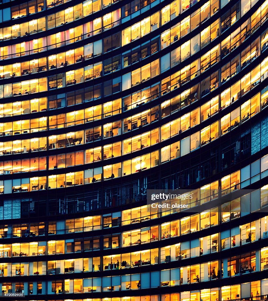 Office building at night with illuminated windows