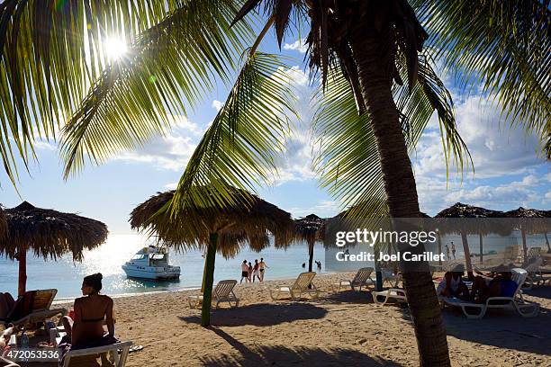 tourists at the beach on playa ancon, trinidad, cuba - playa ancon stock pictures, royalty-free photos & images