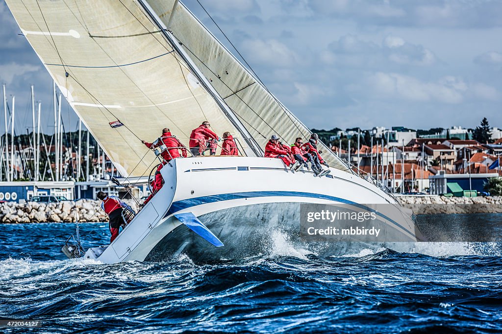 Sailing crew on sailboat during regatta