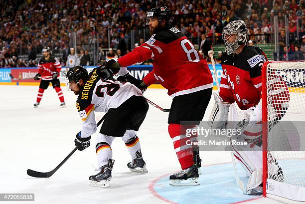 Brent Burns of Canada battles for position with Yannic Seidenberg of Germany during the IIHF World Championship group A match between Canada and...