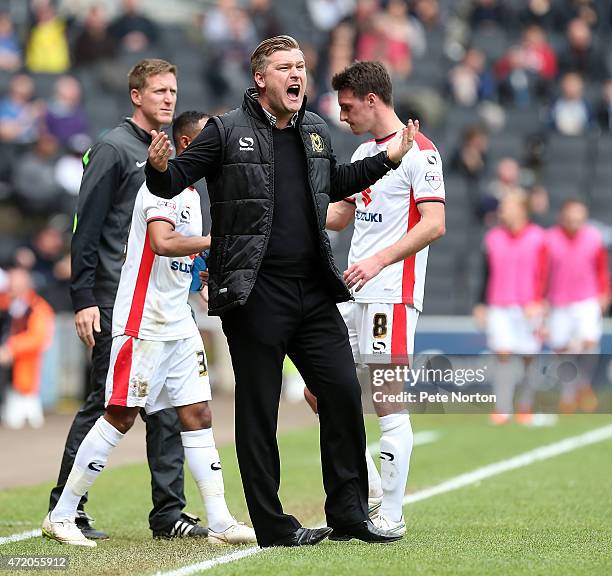 Dons manager Karl Robinson shouts encouragement to his players during the Sky Bet League One match between MK Dons and Yeovil Town at Stadium mk on...