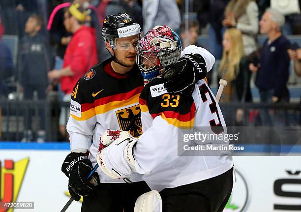 Moritz Mueller of Germany comforts team mate Danny aus den Birken after the IIHF World Championship group A match between Canada and Germany on May...