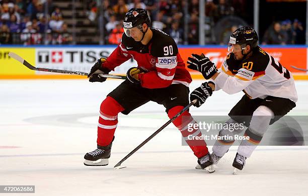 Jason Spezza of Canada and Patrick Hager of Germany battle for the puck during the IIHF World Championship group A match between Canada and Germany...