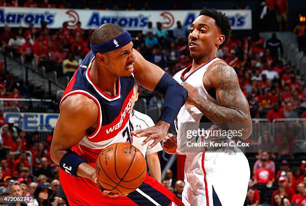 Jeff Teague of the Atlanta Hawks defends against Paul Pierce of the Washington Wizards during Game One of the Eastern Conference Semifinals of the...