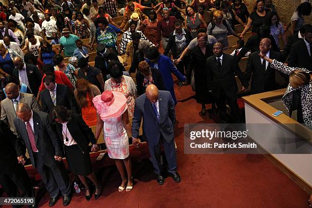 Maryland Lt. Gov., Boyd Rutherford, his wife Monica, Maya Rockeymoore Cummings, wife of Rep. Elijah Cummings , and Elijah Cummings pray at the...