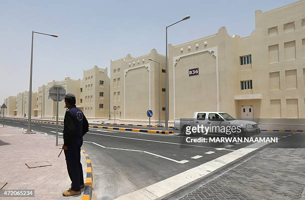 Security stand in a street of new labour city in Doha, on May 3 which was built by the Qatari government and will be housing some 75,000 foreign...
