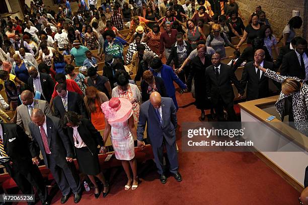 Maryland Lt. Gov., Boyd Rutherford, his wife Monica, Maya Rockeymoore Cummings, wife of Rep. Elijah Cummings , and Elijah Cummings pray at the...