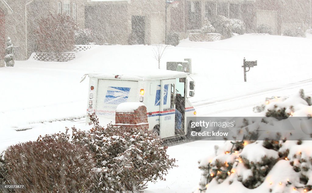 United States Postal Service truck Delivers during a Snow Storm