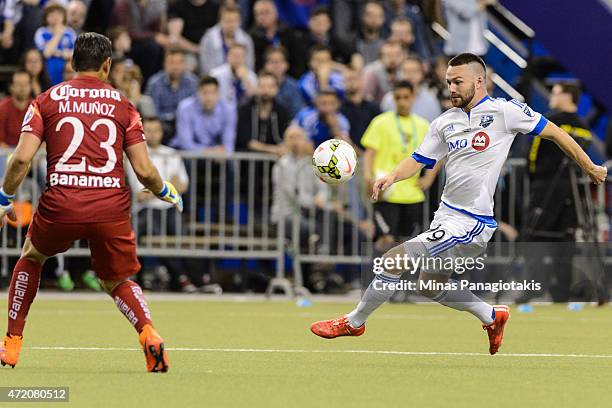 Jack McInerney of the Montreal Impact tries to play the ball near Moises Munoz of Club America in the 2nd Leg of the CONCACAF Champions League Final...