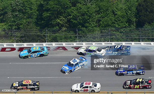 Clint Bowyer, driver of the PEAK Commercial & Industrial Toyota, Casey Mears, driver of the GEICO Chevrolet, and Ricky Stenhouse Jr., driver of the...