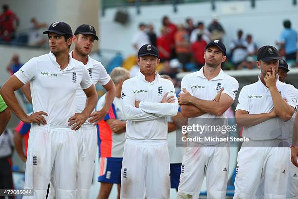 Alastair Cook the captain of England looks on at the after match presentations alongside Stuart Broad, Ian Bell, James Anderson and Jonathan Trott as...