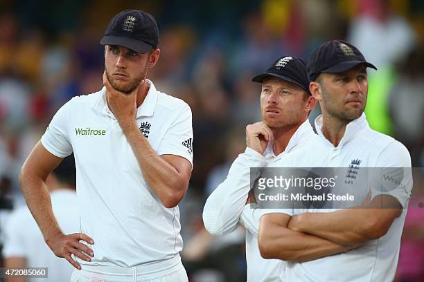 Stuart Broad of England looks on at the after match presentations alongside Ian Bell and Jonathan Trott as the series was squared 1-1 after West...