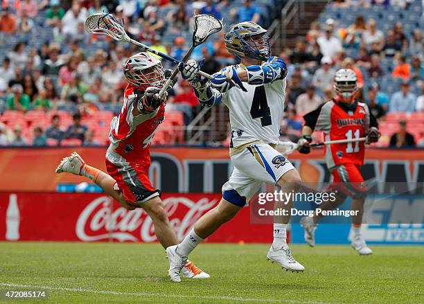 Mike Sawyer of the Charlotte Hounds controls the ball against Domenic Sebastiani of the Colorado Outlaws at Sports Authority Field at Mile High on...