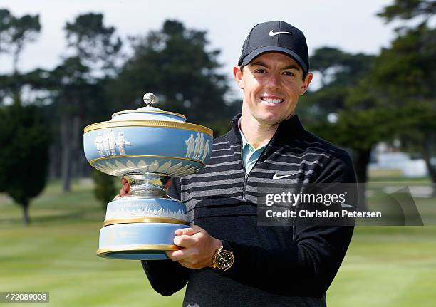 Rory McIlroy of Northern Ireland lifts the Walter Hagen Cup after defeating Gary Woodland 4&2 in the championship match of the World Golf...