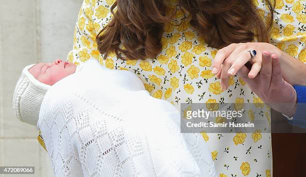 Prince William, Duke of Cambridge and Catherine, Duchess Of Cambridge hold hands as they depart the Lindo Wing with their new baby daughter at St...