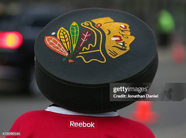 Fan with a foam puck hat walks in the United Center before Game Two of the Western Conference Semifinals during the 2015 NHL Stanley Cup Playoffs...