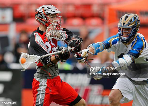 Drew Snider of the Denver Outlaws takes a shot against Kevin Drew of the Charlotte Hounds at Sports Authority Field at Mile High on May 3, 2015 in...
