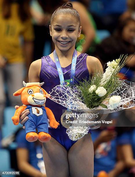 Flavia Saraiva of Brazil celebrates on the podium after winning the Floor competition during day two of the Gymnastics World Challenge Cup Brazil...