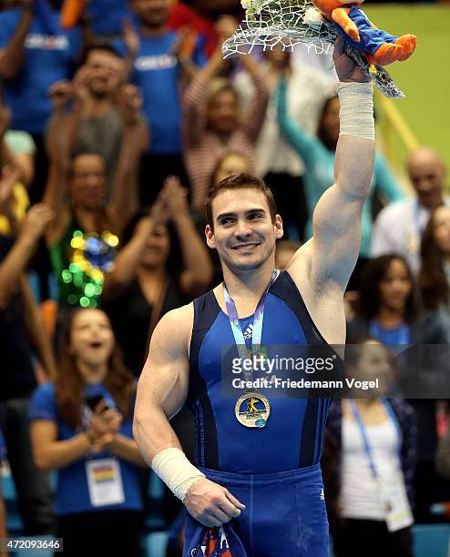 Arthur Nabarrete Zanetti of Brazil celebrates on the podium after winning the Rings competition during day two of the Gymnastics World Challenge Cup...