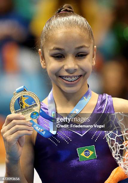 Flavia Saraiva of Brazil celebrates on the podium after winning the Floor competition during day two of the Gymnastics World Challenge Cup Brazil...