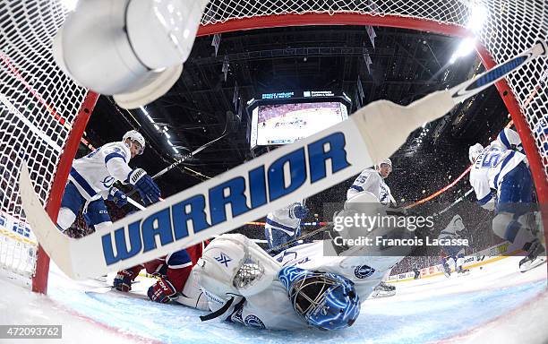Torrey Mitchell of the Montreal Canadiens collides with goaltender Ben Bishop of the Tampa Bay Lightning in Game 2 of the Eastern Conference...