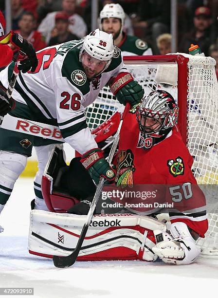 Thomas Vanek of the Minnesota Wild gets called for goal tender interference with this play against Corey Crawford of the Chicago Blackhawks in Game...