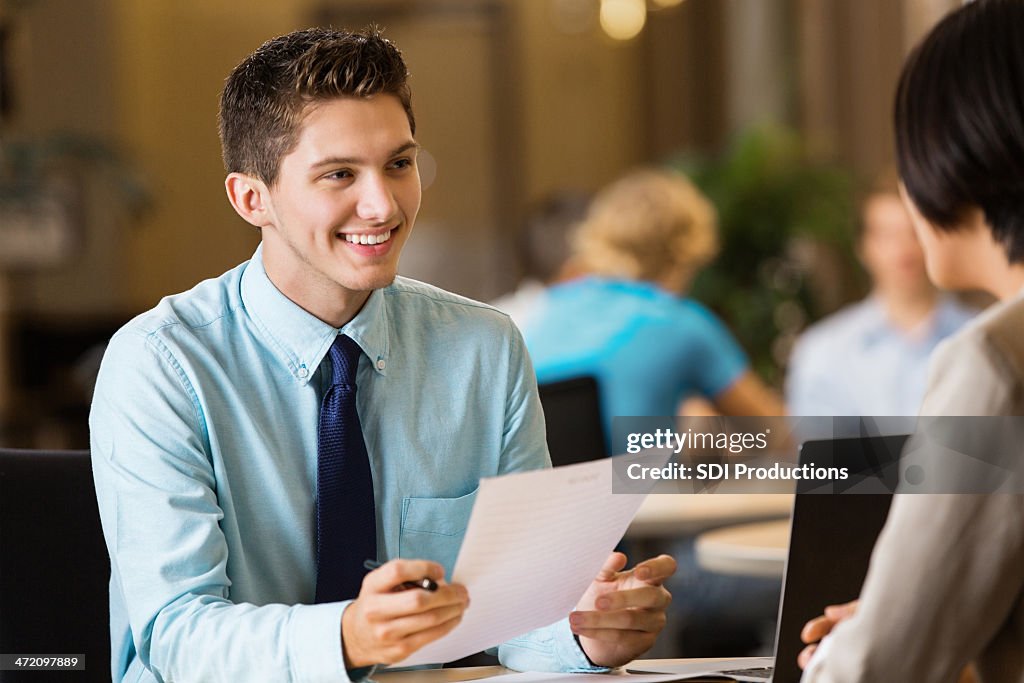 Young professional college student with resume at job interview