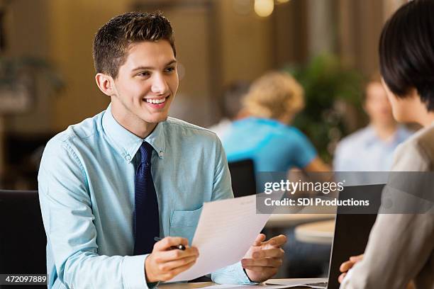 young professional college student with resume at job interview - recruiter bildbanksfoton och bilder