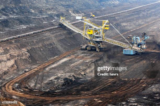 open strip coal mine with bucket-wheel excavator at conveyor belt - surface mining stock pictures, royalty-free photos & images