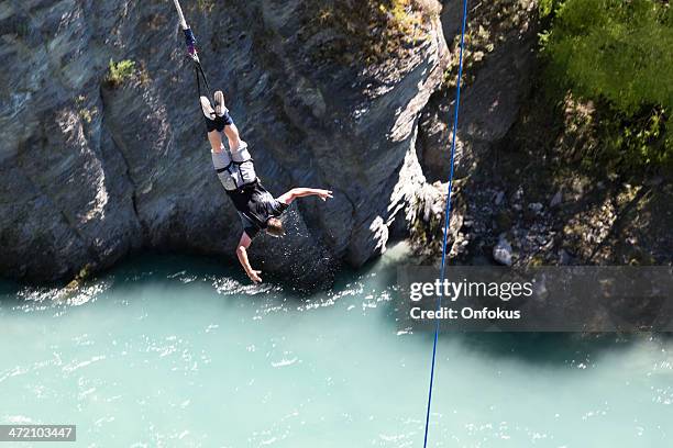 man doing bungee jumping from kawarau bridge, queenstown, new zealand - bungee cord stock pictures, royalty-free photos & images