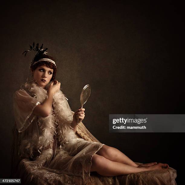 retro beauty looking at herself in a silver hand mirror - 1920 fashion stock pictures, royalty-free photos & images