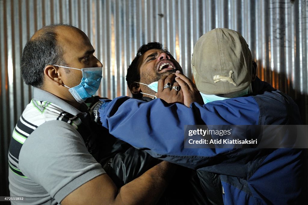 A Nepalese man mourns during the cremation of his kin who...