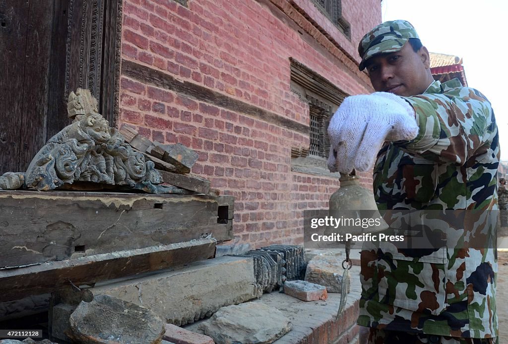 An army shows the item that he found from a debris house.