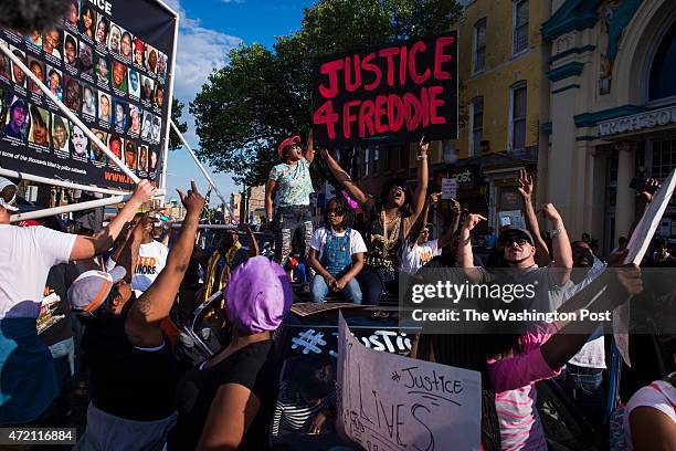 Protestors shout and chant after they marched from City Hall to the intersection of West North Avenue and Pennsylvania Avenue in solidarity with...