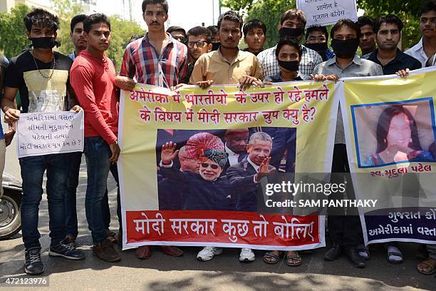 Members of the National Students Union of India participate in a protest in Ahmedabad on May 4, 2015 holding banners of Indian Prime Minister...