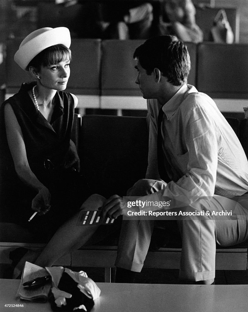 Audrey Hepburn and Anthony Perkins seated side by side