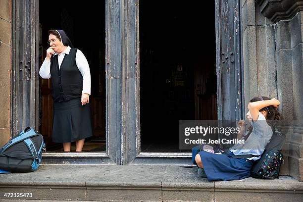 catholic nun and school girl on church steps - catholic church stock pictures, royalty-free photos & images